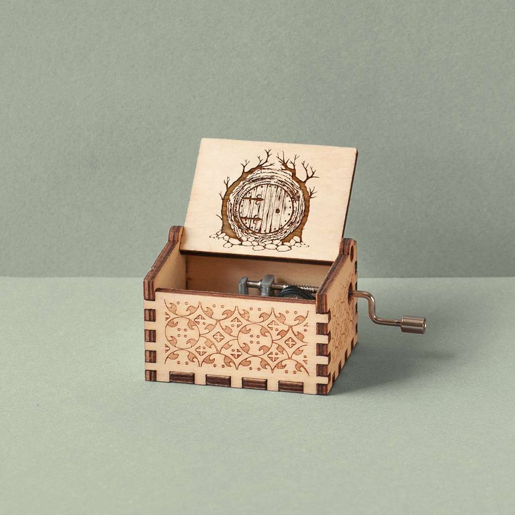 Engraved music box with a Hobbit house